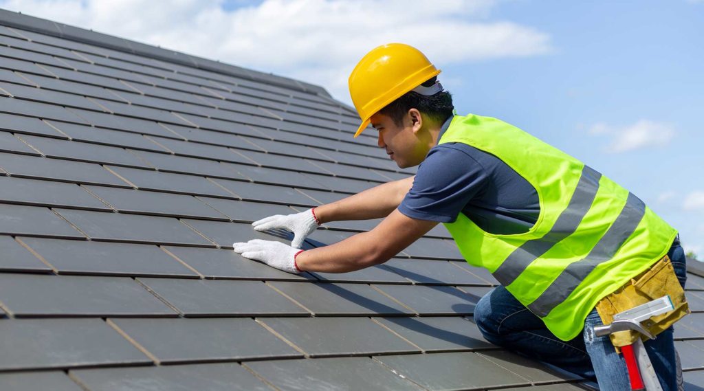 image of construction worker installing roof