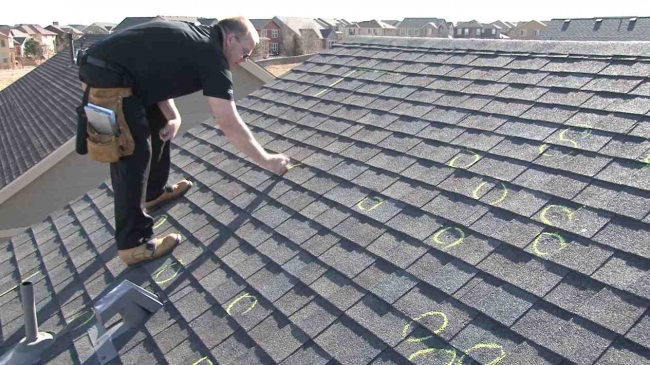 image of man inspecting roof